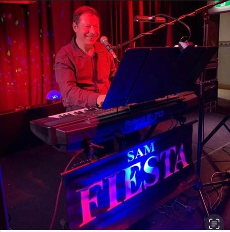 A singer on keys playing live at the club